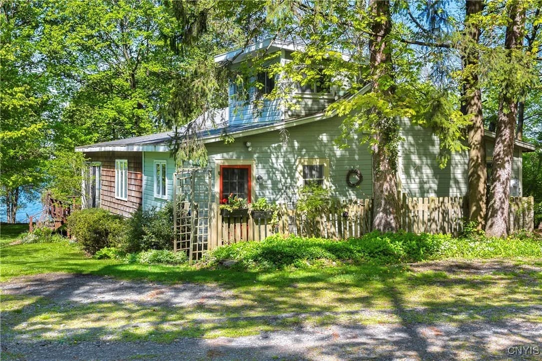 Green exterior of The Lake House among mature trees